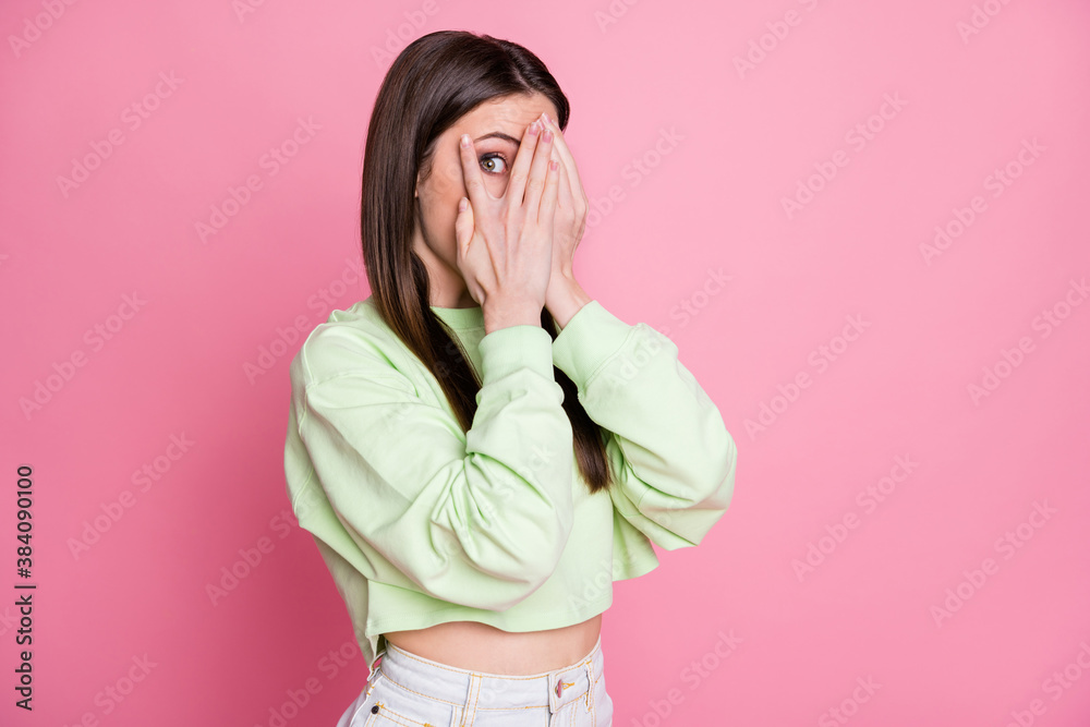 Photo of attractive funny lady closing eyes arms peeking glance wanna know secret curious person wear casual green crop sweatshirt pullover isolated pink pastel color background - obrazy, fototapety, plakaty 