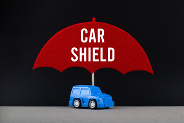 Wall Mural - Concept of car insurance. Blue car under red umbrella with text Car shield.