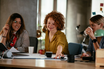 Wall Mural - Businesswomen working on a new project. Colleagues discussing work in office