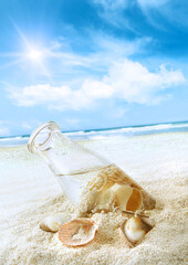 Poster - Bottle with seashells in the sand 