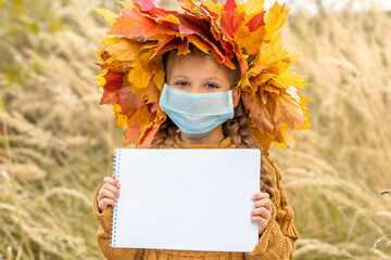Wall Mural - A little girl with a medical mask on her face.