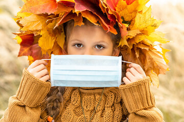 Wall Mural - A child holds a medical mask against coronavirus.