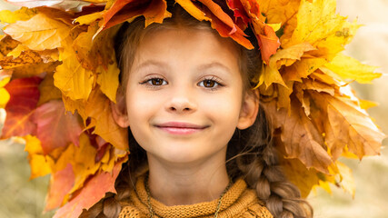 Wall Mural - A little girl with an autumn wreath on her head.