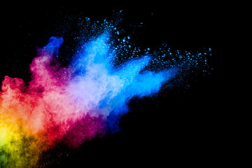 Wall Mural - Colorful powder explosion on black background. Abstract pastel color dust particles splash.