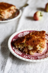 Wall Mural - Apple and Cheese Cobbler Crisp. Cobbler or Crumble dessert with apples on plates on beige linen table. Selective focus