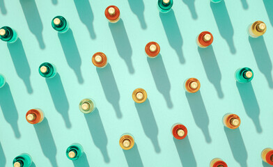 Leinwandbilder - Top view of many closed glass beer bottles mockups standing on turquoise blue background.