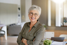 Portrait Of A Beautiful Smiling 55 Year Old Woman With White Hair