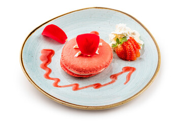 Wall Mural - Pink dessert Macarons with cream and strawberries on a blue plate