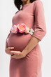 © LIGHTFIELD STUDIOS - partial view of pregnant woman with floral belt standing isolated on white