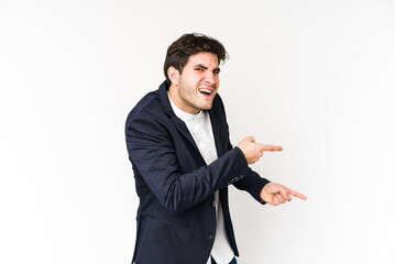 Wall Mural - Young business man isolated on white background pointing with forefingers to a copy space, expressing excitement and desire.