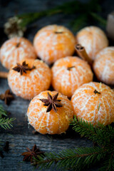 Wall Mural - New year's composition with tangerines, spices and Christmas tree branches, a symbol of the New Year, selective