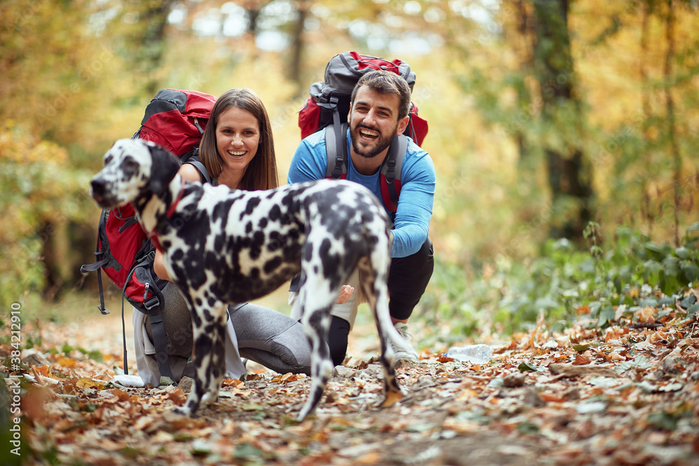 Hikers couple posing for a photo with their dog Stock Photo | Adobe Stock