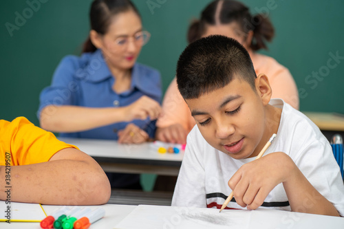 disability kid on wheelchair with Autism child in special classroom