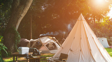Wall Mural - field tents group and wooden table set with outdoor kitchen equipment in camping area at natural par