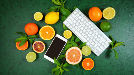 Wall Mural - Health food theme background workspace with citrus fruit on dark green textured background. Top view blog hero header creative composition flat lay with negative copy space.