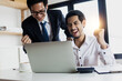 © khwanchai - business people looking at laptop and celebrate and glad after office achieve profit and get goal