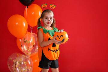 Sticker - Cute little girl with pumpkin candy bucket and balloons wearing Halloween costume on red background. Space for text