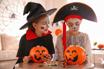 Sticker - Cute little kids with pumpkin candy buckets wearing Halloween costumes at home