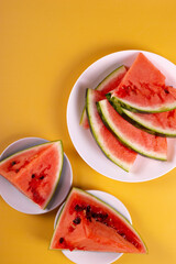 Wall Mural - fresh and ripe watermelon on yellow background. minimalism style