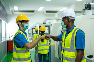 Poster - engineer greeting bumping elbows in factory,new novel greeting to avoid the spread of coronavirus.