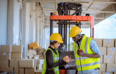 Industry workers helping to move produce boxes for folklife truck to keep on factory warehouse ,they look  produce detail on tablet with factory background