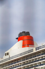 Red And Black Funnel Of Classic Cunard Ocean Liner Or Cruise Ship Or Cruiseship QM2 Queen Mary 2 Against Grey Sky During Ocean Cruise In Winter