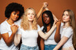 © iordani - young pretty asian, caucasian, afro woman posing cheerful together on brown background, lifestyle diverse nationality people concept