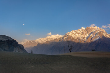 katpana cold desert in skardu  ,dunes with snow mountain in background, northern areas of gilgit Baltistan Pakistan