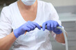 © Alla - Dental saliva pump in the hands of an assistant. Hands in protective gloves. Concept of health care and disease prevention. Dental equipment. Unrecognizable person.