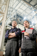 Poster - Young successful male and female engineers of large contemporary warehouse