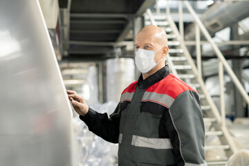 Poster - Bald mature worker of contemporary large polymer processing factory