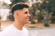 © Vulp - Side view portrait young cheerful man looking away while standing outdoor in park