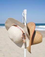 Sun, sea, sky, male and female straw hats on summer