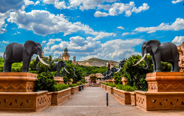 entrance of the palace / lost city /sun city with stone statues under blue and cloudy sky