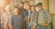 © VAKSMANV - Portrait of happy Caucasian family of three generations standing outdoor at hay stocks and smiling to camera. Old parents with children and grandchildren in countryside. Farmers at farm. Summer.