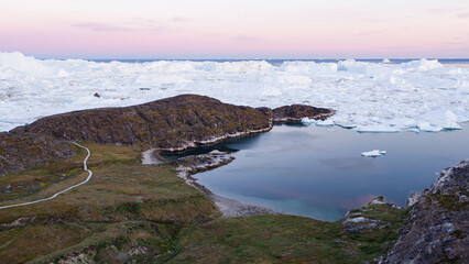 Wall Mural - arctic landscape nature with icebergs and ice in greenland icefjord. aerial drone image of ice and i