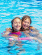 © Susan - Sisters splash in a pool together