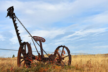 An Image Of An Old Rusted Vintage Horse Drawn Hay Mower.