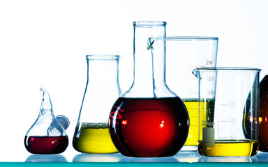 Wall Mural - different laboratory glassware with color liquid and with reflection