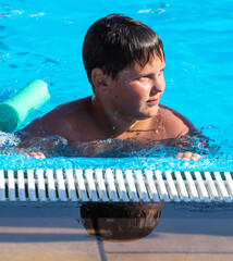 Wall Mural - The boy swims in the pool