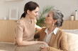 © ty - Elderly middle mother sitting on couch with joy holding adult daughter on knees. Happy trusted relations. Family concept.