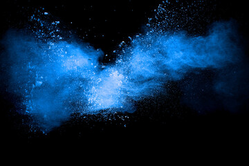Wall Mural - Blue color powder explosion cloud on black background.Closeup of Blue dust particles exhale.