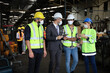 © torsakh - Leader or manager using tablet and meeting with engineer and technician while line walk in factory workplace, team wear face mask whine working at maintenance machine shop