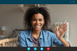 © fizkes - Screen application view of smiling millennial African American woman wave greet talking on video call at home. Happy young biracial female have pleasant webcam digital virtual online conference.