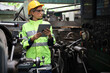 © torsakh - A Engineer woman using tablet or computer for inspect or checking or adjust or operate control the machine in workshop factory, the technician repair or maintenance part or equipment