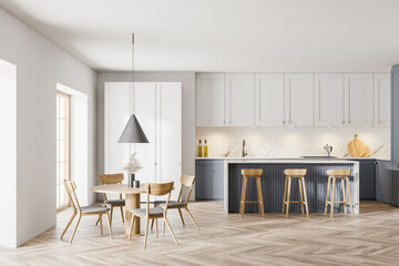 Modern white and gray kitchen with dining table and bar