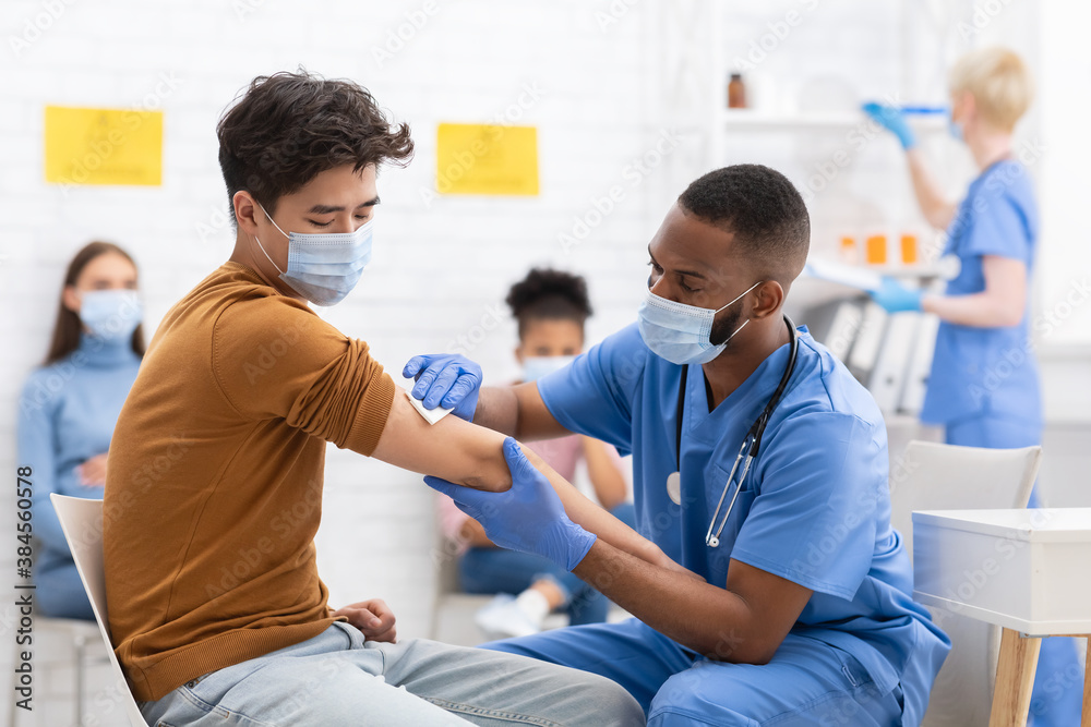 Asian Male Patient Getting Vaccinated Against Coronavirus In Hospital - obrazy, fototapety, plakaty 