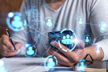 double exposure of man signing contract with phone and social network icon hologram. concept of inte