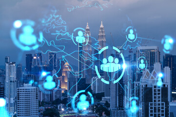 Glowing Social media icons on night panoramic city view of Kuala Lumpur, Malaysia, Asia. The concept of networking and connections between people and businesses in KL. Double exposure.