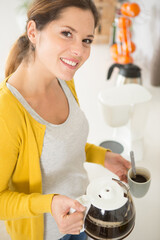 woman in the home holding a filter coffee pot